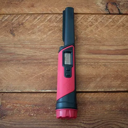 Metal detector on a wooden table.
