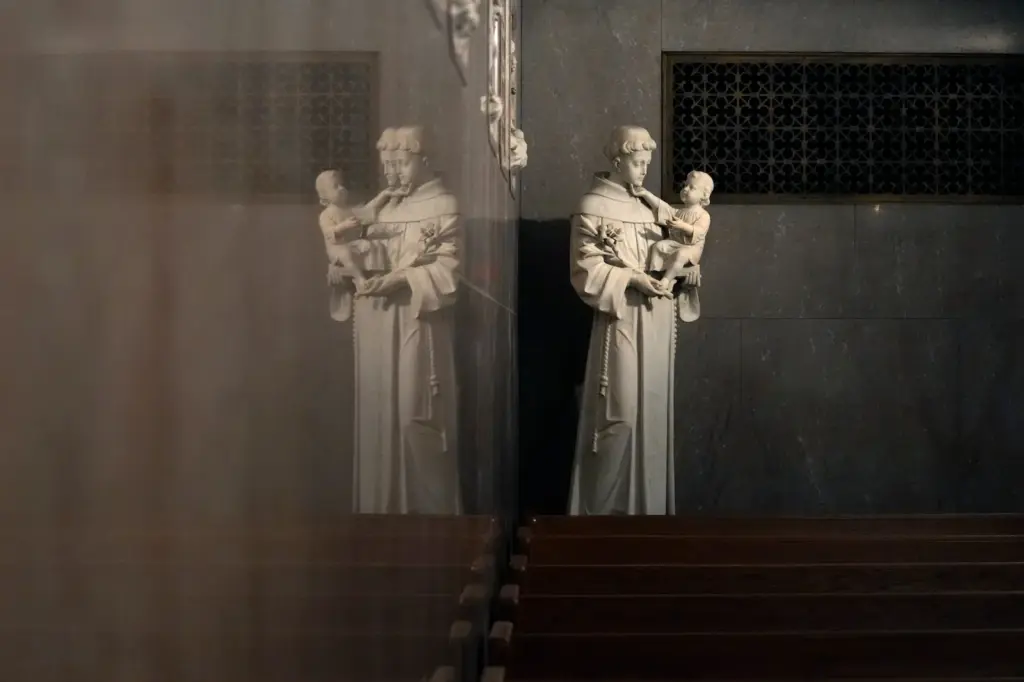 St. Anthony holding the infant Jesus is reflected in a wall in St. Aloysius Catholic Church