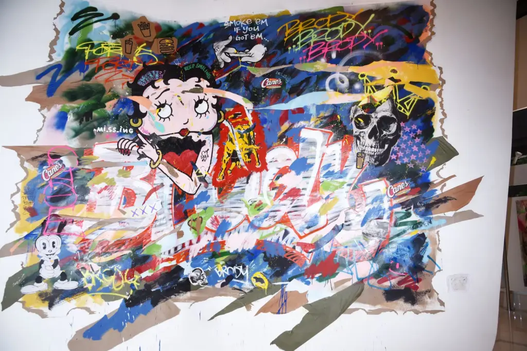 Los críticos se ríen de la obra artística de Adrien Brody: perros con bandana, pollo frito y un mural a lo Warhol