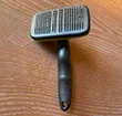 Self-cleaning hair removal brush