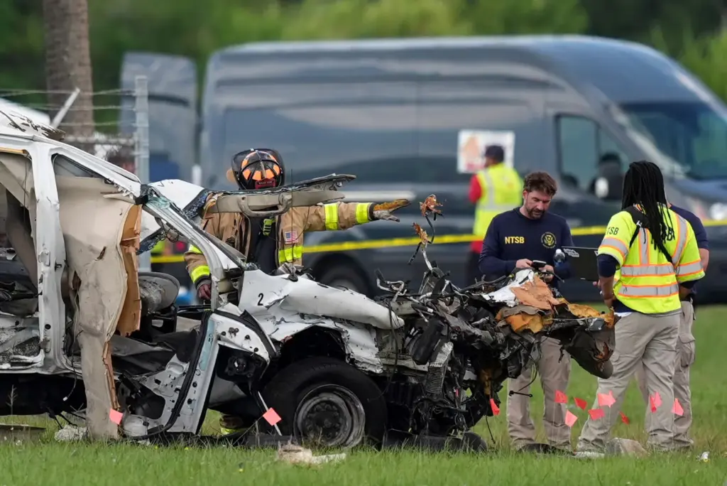 Emergency teams inspect a damaged vehicle after the accident