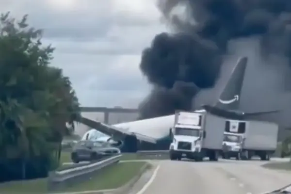 An Amazon cargo plane skids off the runway at Miami airport and ends up in flames
